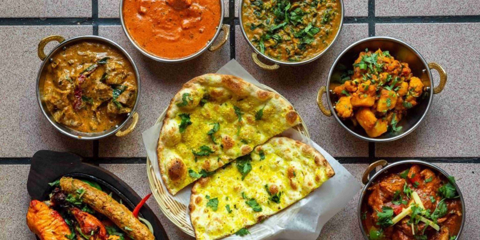 A table filled with Everest Masala Indian dishes